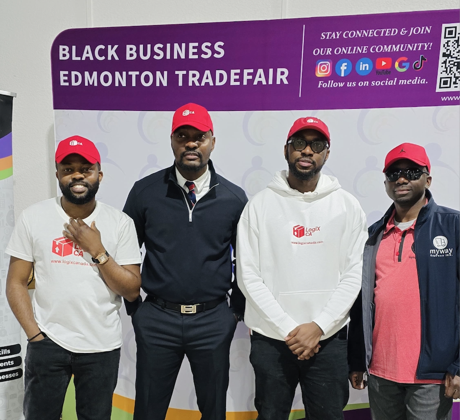 LogiX Canada team in red caps at the Black Business Edmonton Tradefair backdrop