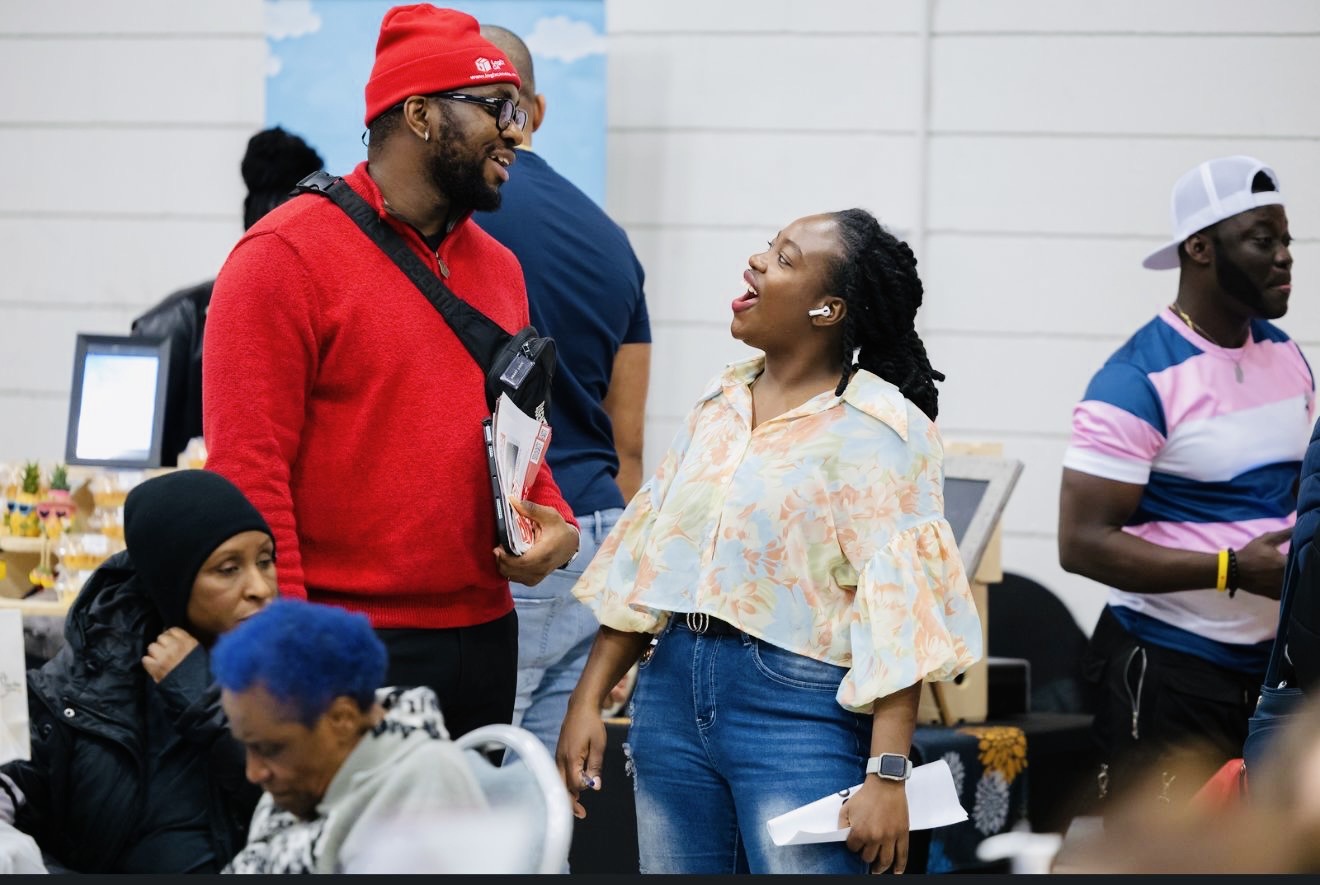 LogiX Canada team member chatting with a festival attendee at the Caribbean Winter Food Festival